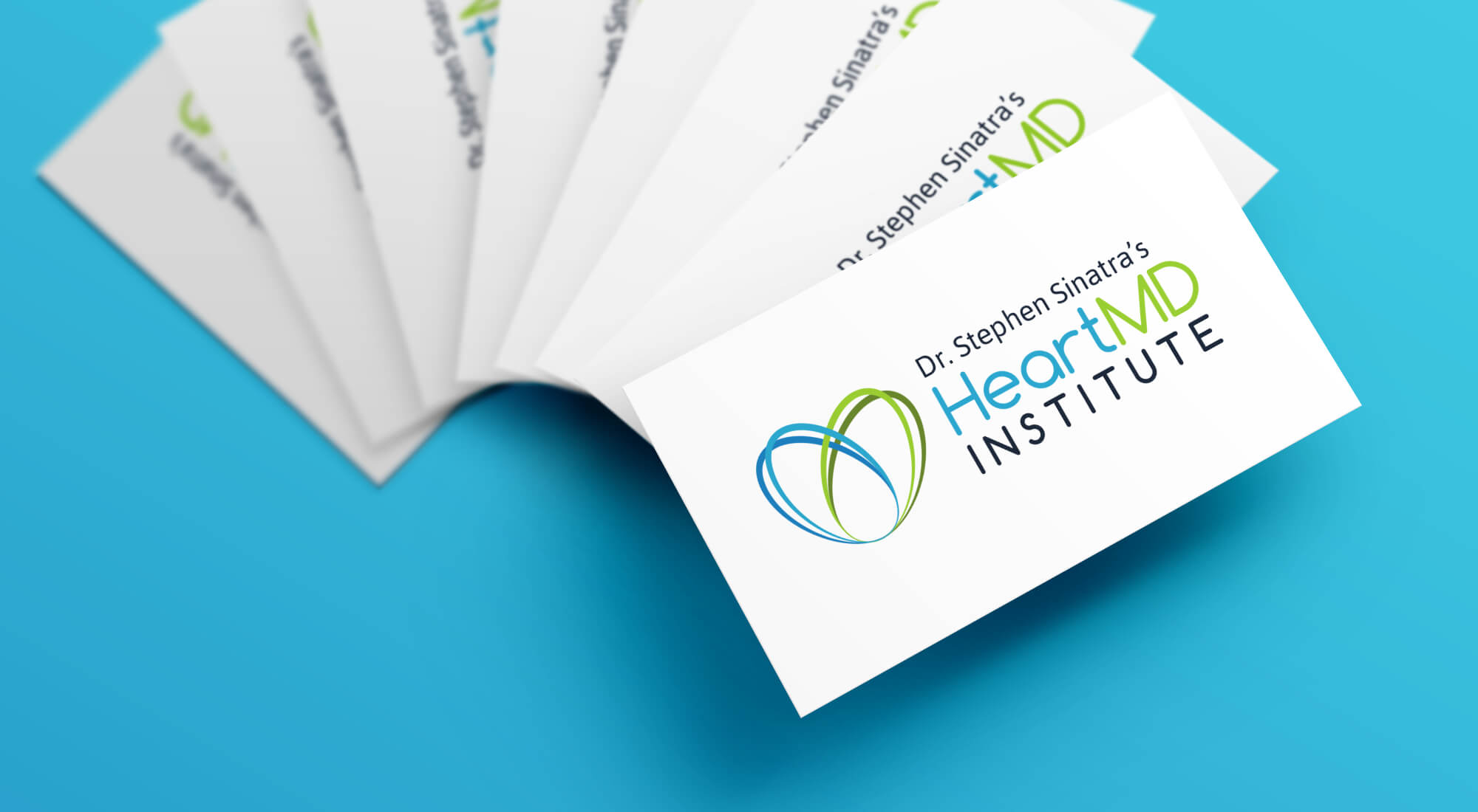 A stack of business cards featuring the logo and name “Dr. Stephen Sinatra’s HeartMD Institute” on a blue background.