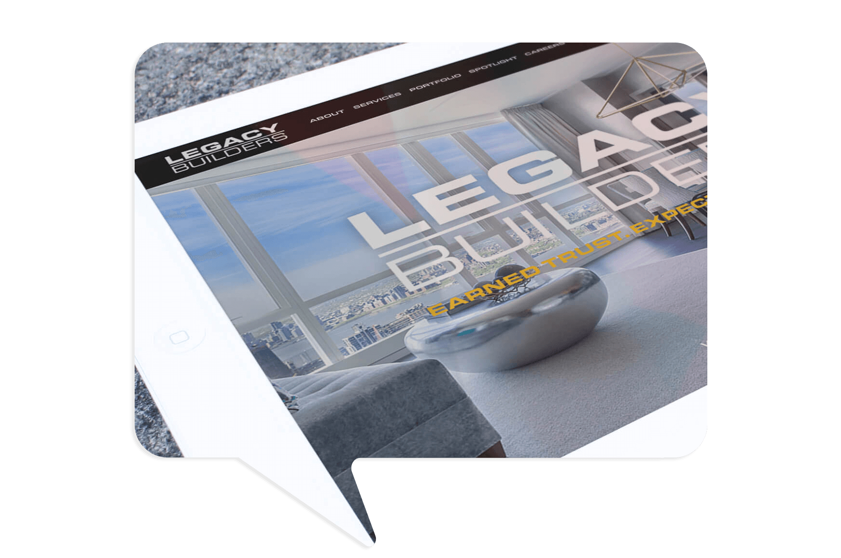 Tablet screen displaying the website for Legacy Builders, showing a modern living room with large windows and city views.