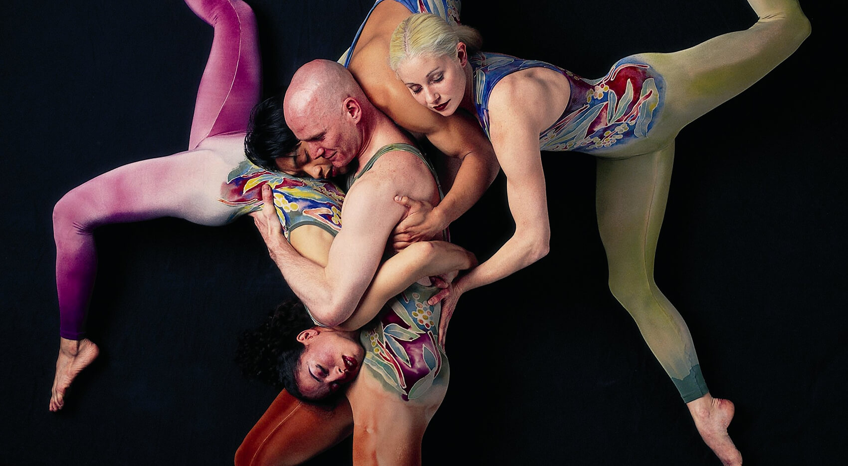 four dancers intertwined