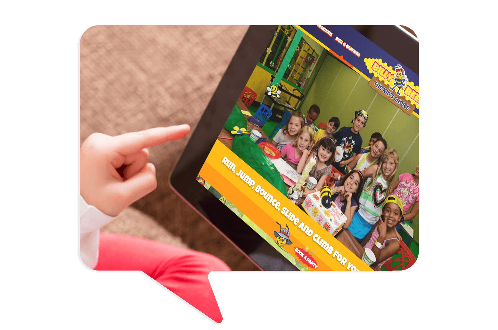 A person points at a tablet displaying a website featuring children smiling around a table in a colorful indoor play area.