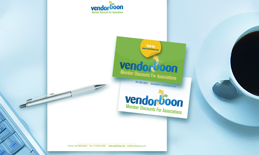 Vendorboon stationery set with a branded letterhead, business card, and pen on a desk near a cup of coffee and a keyboard.