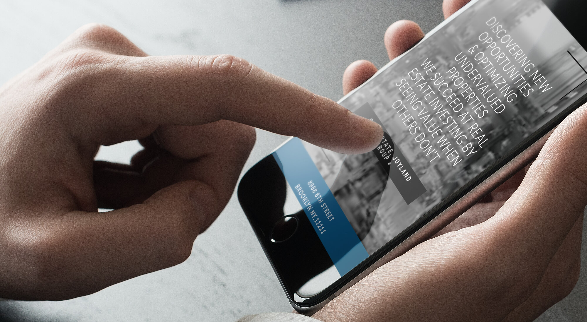 A person uses a smartphone, tapping the screen displaying a website with text about discovering new opportunities and investing.