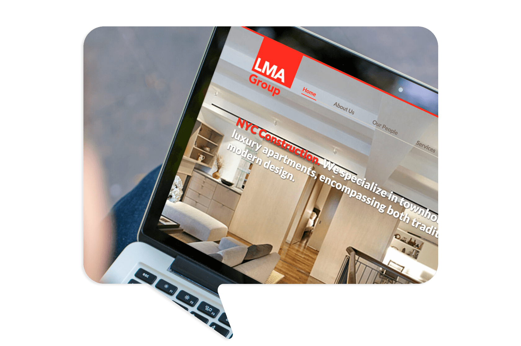 A person holds a laptop displaying the LMA Group website, which features a modern apartment interior and navigation tabs at the top.