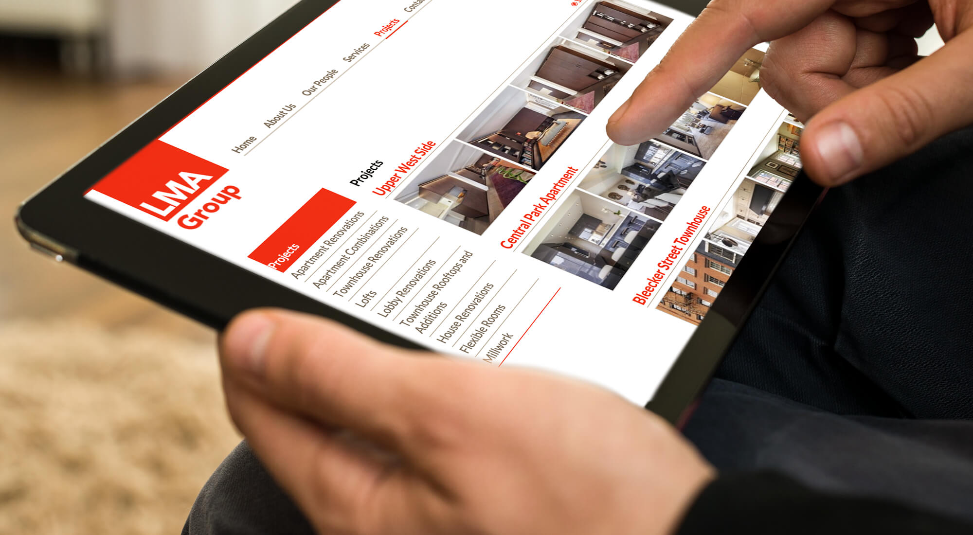 Person uses a tablet to browse a real estate website featuring property listings and photos, with the LMA Group logo visible in the upper left corner.