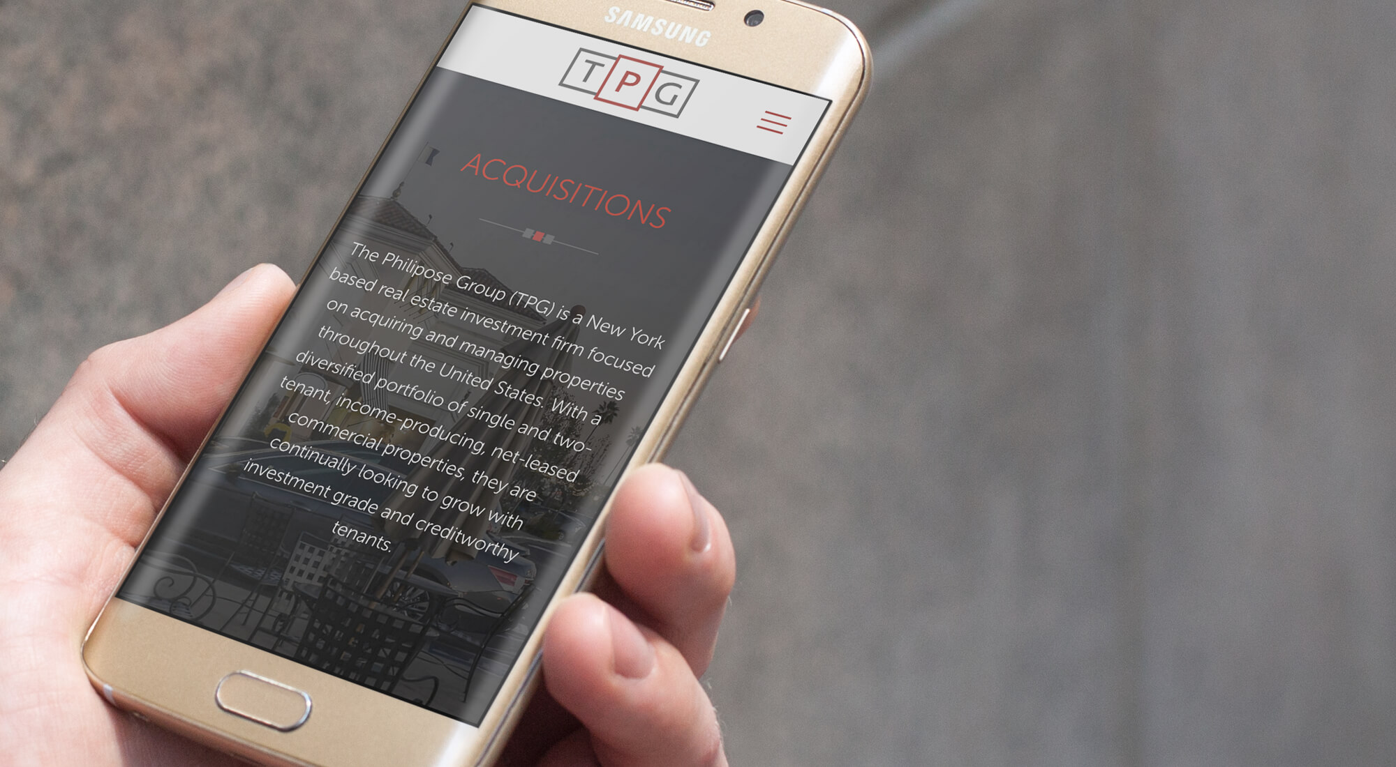 A hand holds a Samsung smartphone displaying a website for TPG, a real estate investment firm, with an "Acquisitions" section visible on the screen.