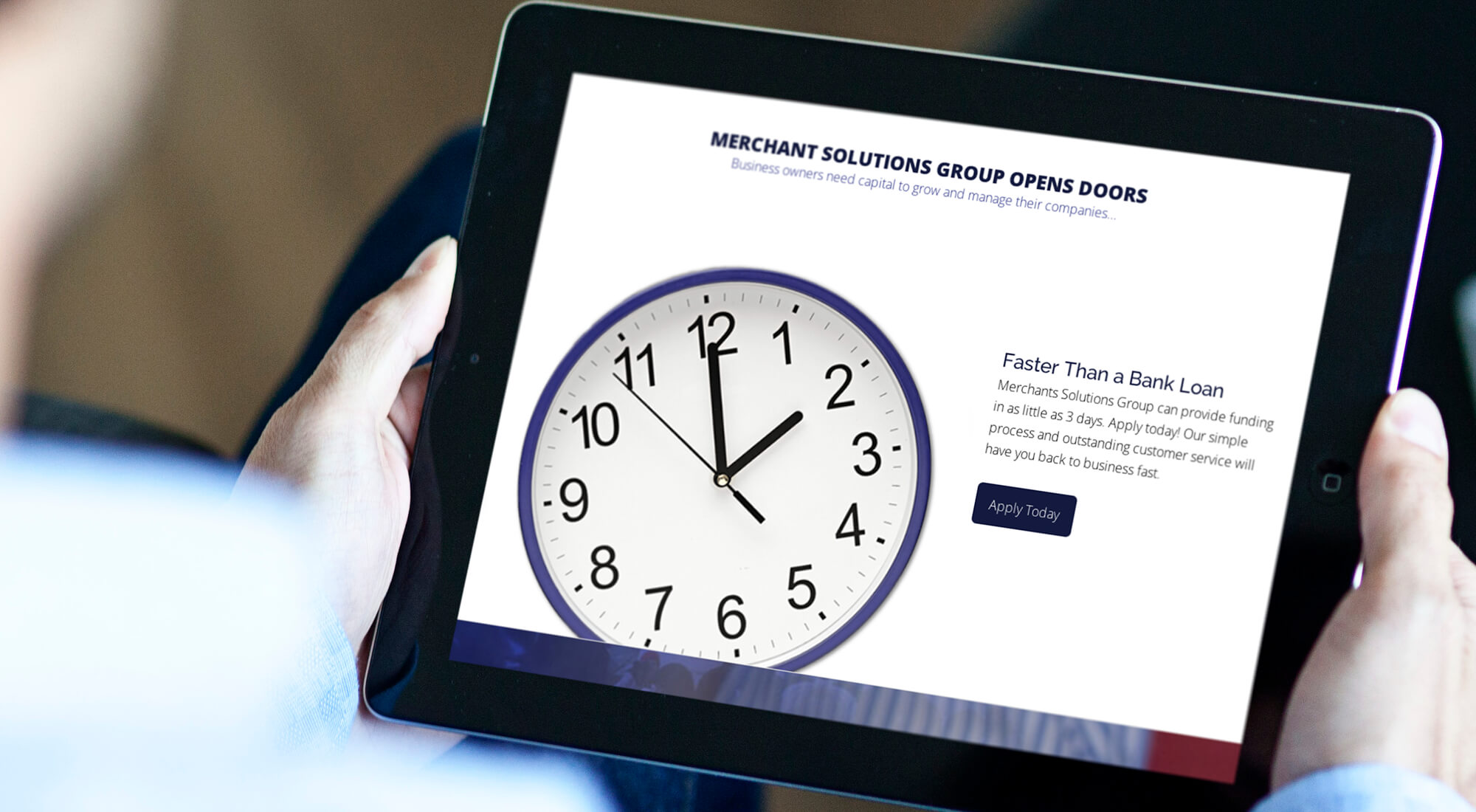 Person holding a tablet displaying a webpage with a large analog clock and information about fast business loans from Merchant Solutions Group, including an "Apply Today" button.