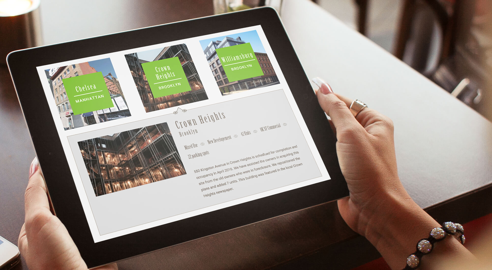 Person holding a tablet displaying a real estate website with listings for Chelsea, Crown Heights, and Williamsburg, including images and text descriptions for each location.