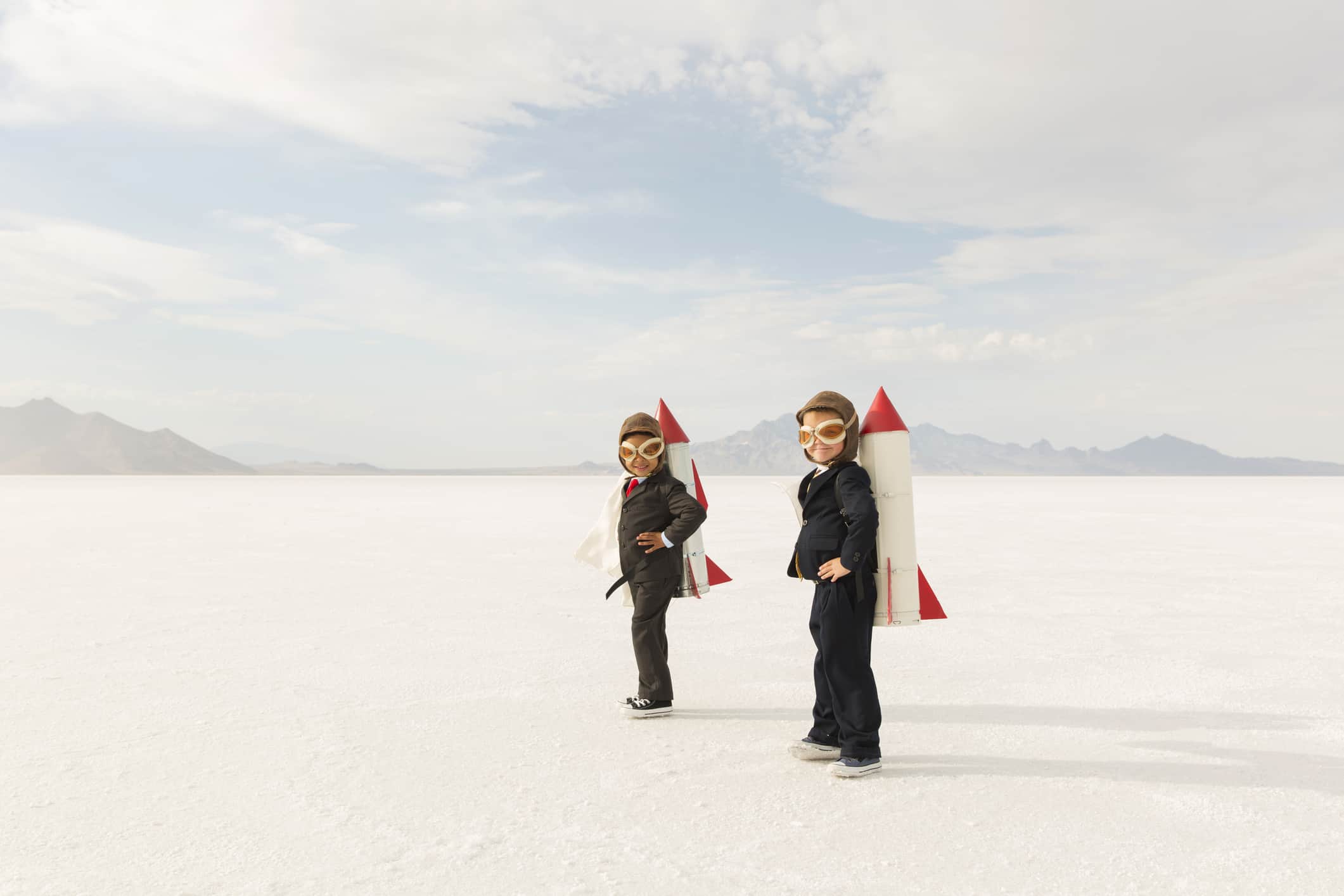 two boys in tuxedos with rockets on their backs