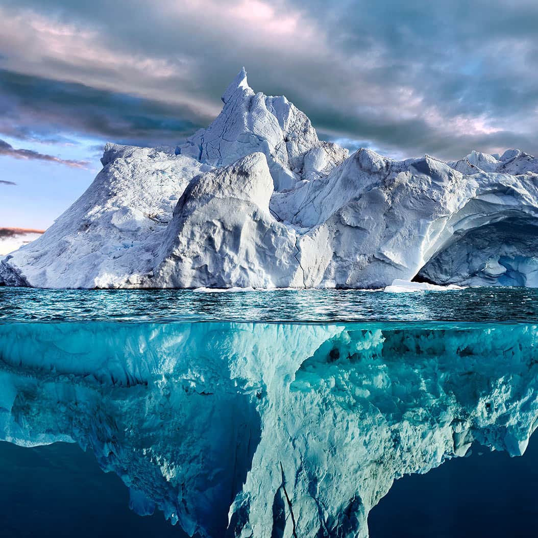 top and bottom view of glacier in water