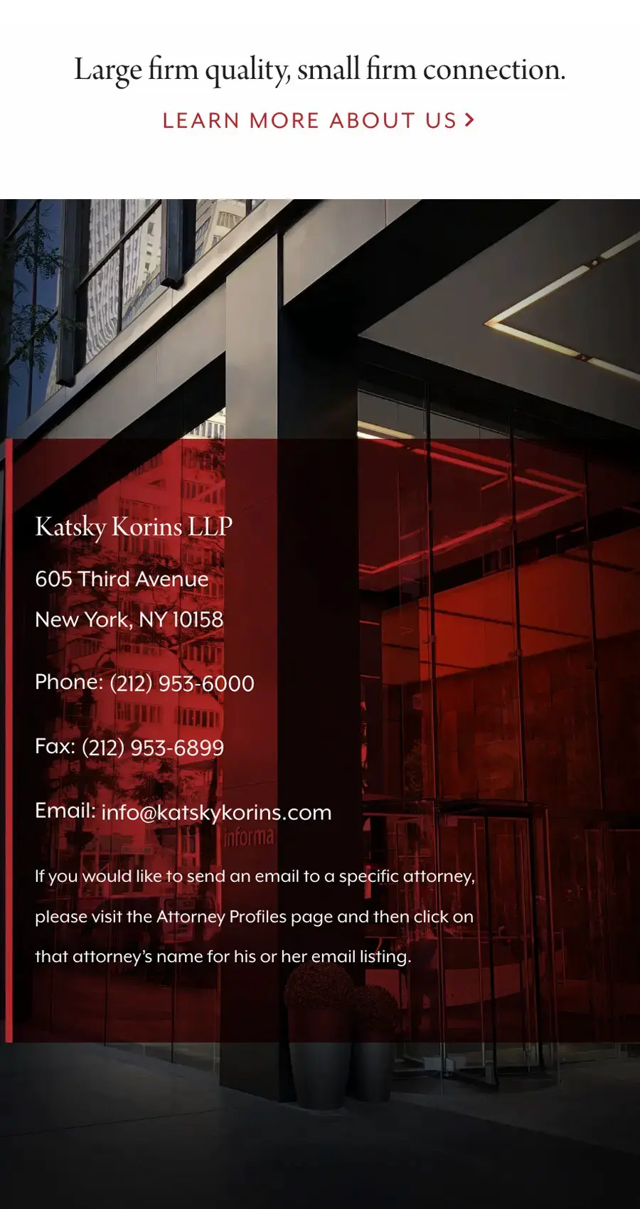 Contact information for Katsky Korins LLP displayed over a photo of a modern building with a glass facade and red interior lighting, highlighting the firm's commitment to ADA Website Compliance.