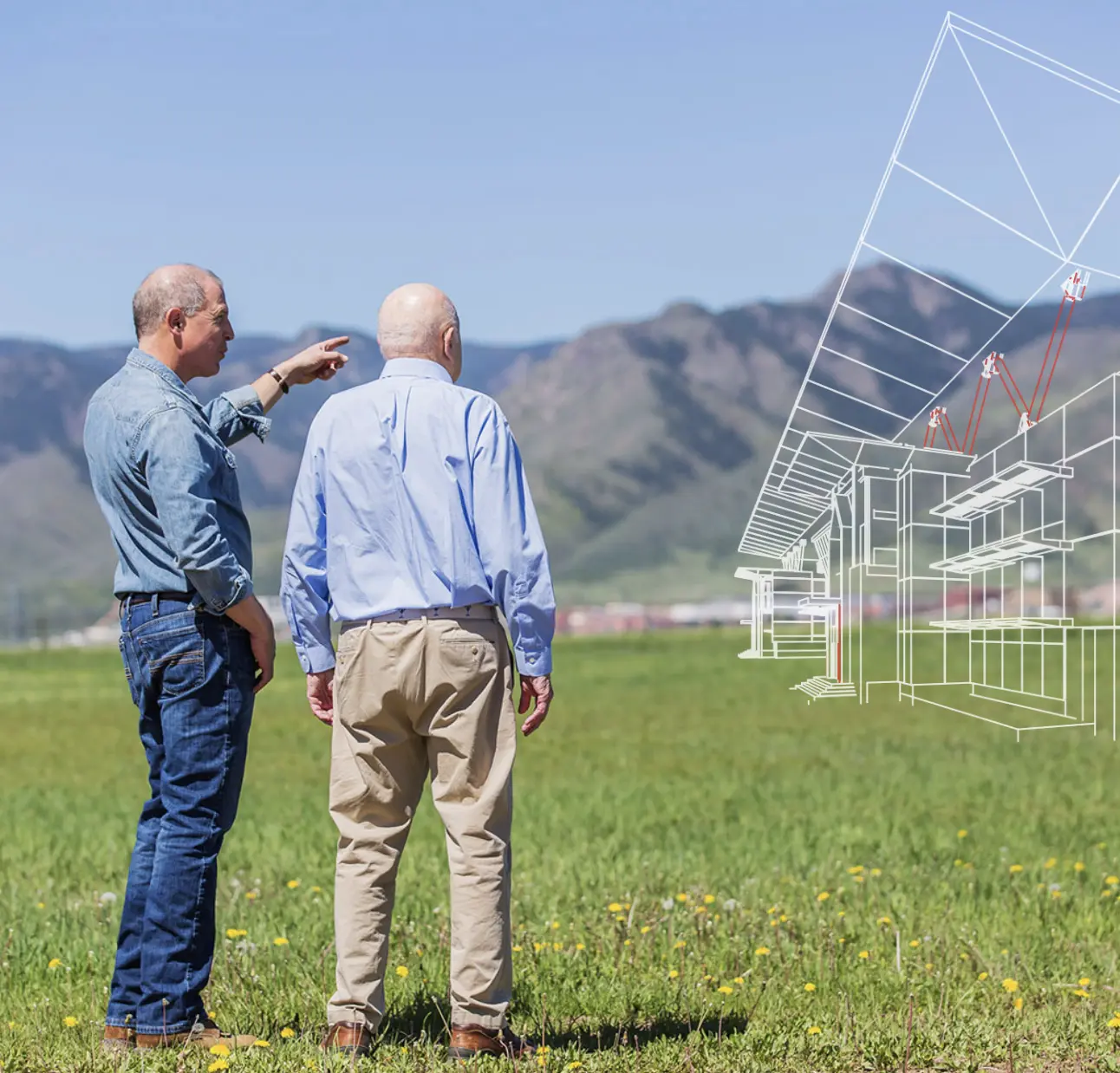 Two men stand in a grassy field with mountains in the background, observing a digital architectural rendering of a building projected in front of them.